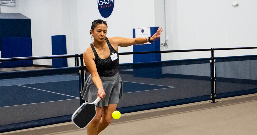 Pickleball player wearing court-ready athletic attire during an indoor match.