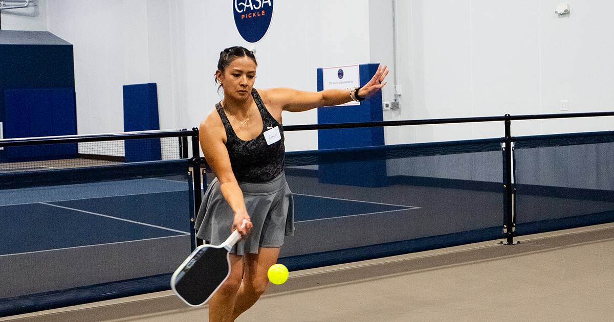 Pickleball player wearing court-ready athletic attire during an indoor match.